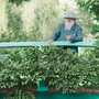 Claude Monet observes his Giverny, France, garden from its Japanese footbridge in this 1922 colorized.