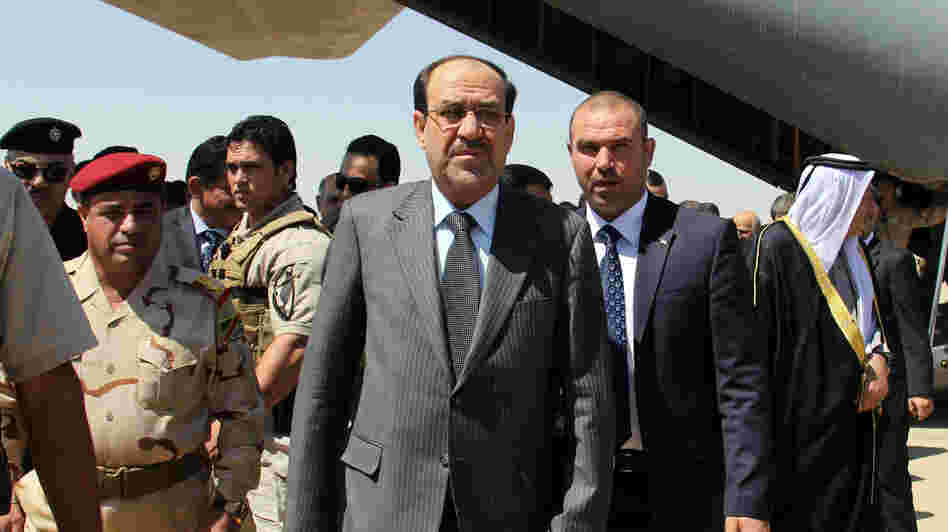 Iraqi Prime Minister Nouri al-Maliki (center) arrives on May 8 at Kirkuk airport in northern Iraq, on his first visit to the multi-ethnic city since taking office.