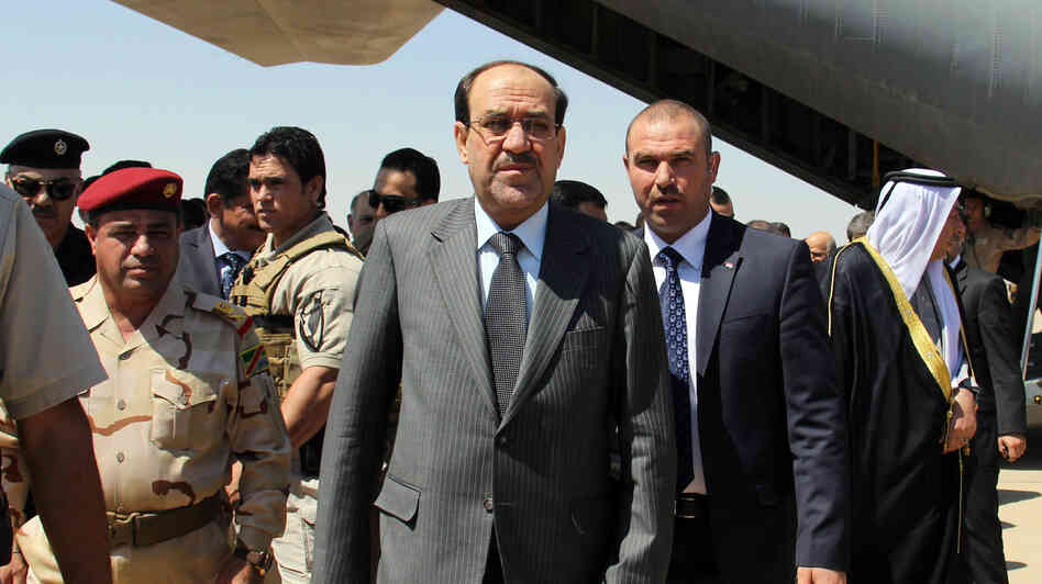 Iraqi Prime Minister Nouri al-Maliki (center) arrives on May 8 at Kirkuk airport in northern Iraq, on his first visit to the multi-ethnic city since taking office.