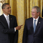 President Barack Obama gestures toward former President George W. Bush, former first lady Laura Bush and first lady Michelle Obama, at the White House in Washington, Thursday, during a ceremony where the Bushs' portraits were unveiled. President Barack Obama gestures toward former President George W. Bush, former first lady Laura Bush and first lady Michelle Obama, at the White House in Washington, Thursday, during a ceremony where the Bushs' portraits were unveiled.