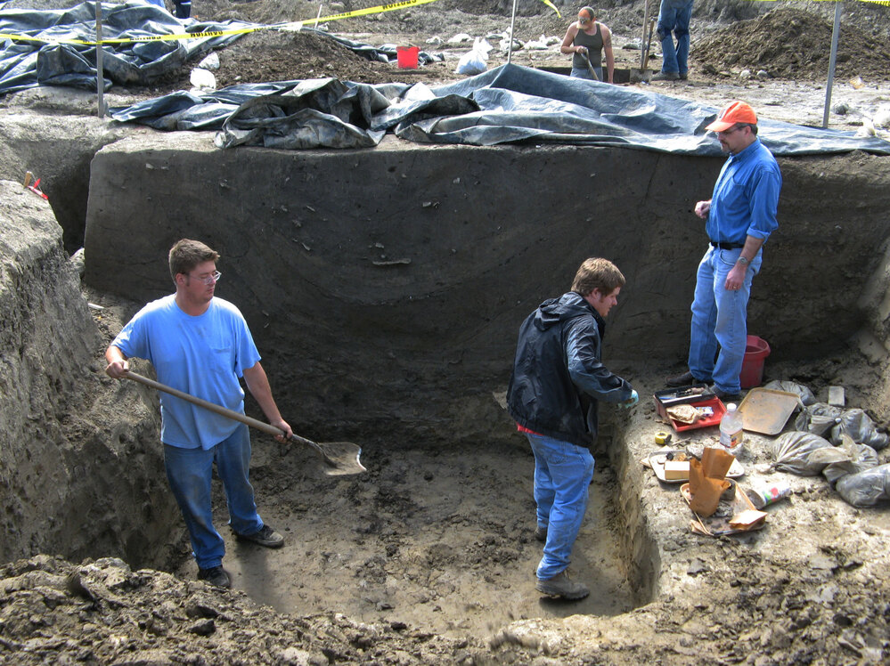 Research coordinator Joe Galloy looks on as crew members excavate a large storage pit at the dig site. Archaeologists are not sure of its original function, but the Cahokians may have used it to store corn or other food. Later on, they threw their trash into it, including the bones of deer and fish, and pieces of broken clay pots and bowls.