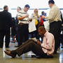 Aaron Moore completes a job application at a Los Angeles career fair on Thursday. Job growth has slowed sharply since the winter, the government said Friday.