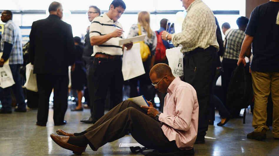 Aaron Moore completes a job application at a Los Angeles career fair on Thursday. Job growth has slowed sharply since the winter, the government said Friday. Aaron Moore completes a job application at a Los Angeles career fair on Thursday. Job growth has slowed sharply since the winter, the government said Friday.
