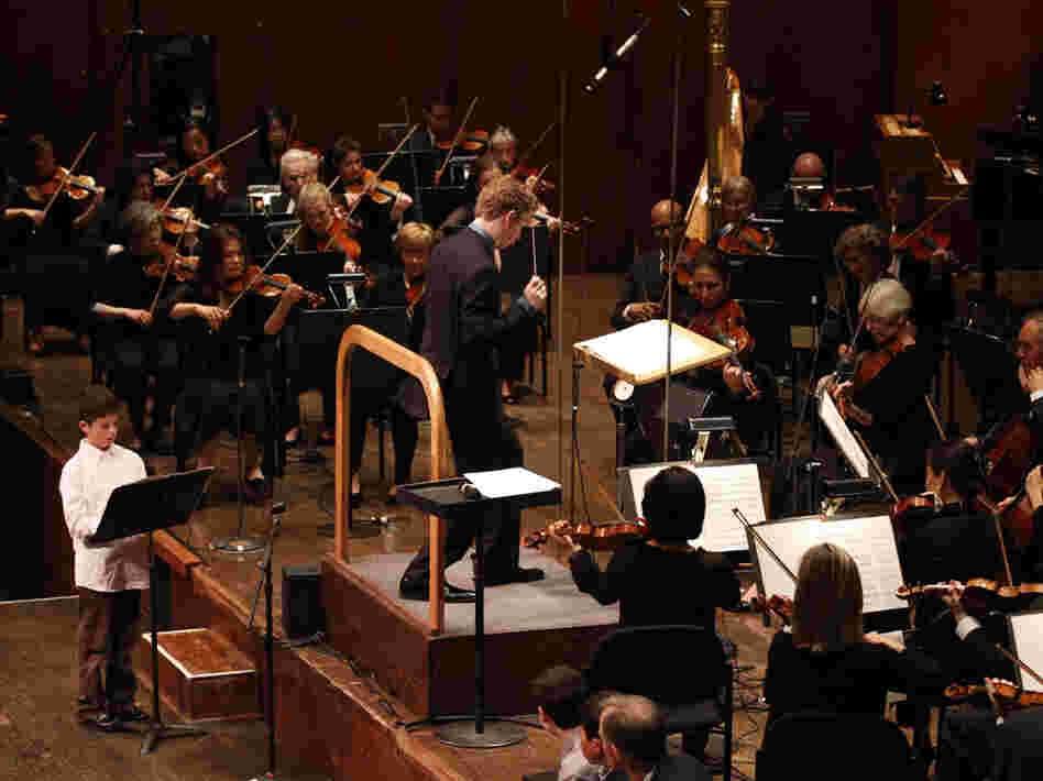 Very Young Composer Milo Poniewozik joins assistant conductor Joshua Weilerstein at the head of the New York Philharmonic. As part of the orchestra's School Day Concerts, Milo's piece was performed in front of more than 2,000 kids.