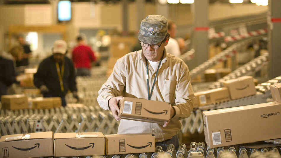 An Amazon worker grabs boxes off a conveyor belt in Nevada, one of a handful of states in which the online retailer collects sales tax.