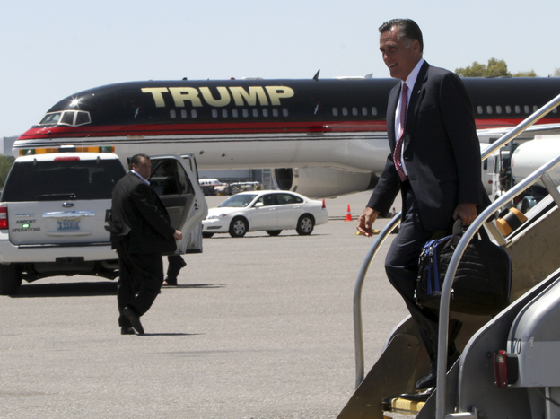 Republican presidential candidate Mitt Romney walks past Donald Trump's airplane as he arrives in Las Vegas on Tuesday, where he met with Trump for a fundraiser.
