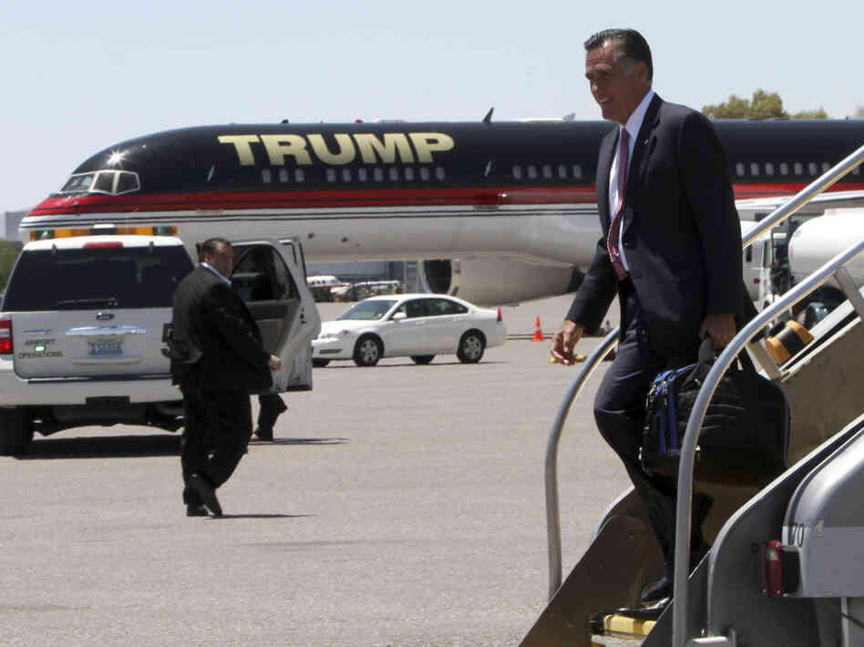 Republican presidential candidate Mitt Romney walks past Donald Trump's airplane as he arrives in Las Vegas on Tuesday, where he met with Trump for a fundraiser.