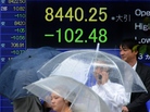 Slow economic growth in the U.S. is having an impact on many countries around the world. Here, people walk past a board flashing the Nikkei index on the Tokyo Stock Exchange in Japan last month. Slow economic growth in the U.S. is having an impact on many countries around the world. Here, people walk past a board flashing the Nikkei index on the Tokyo Stock Exchange in Japan last month.