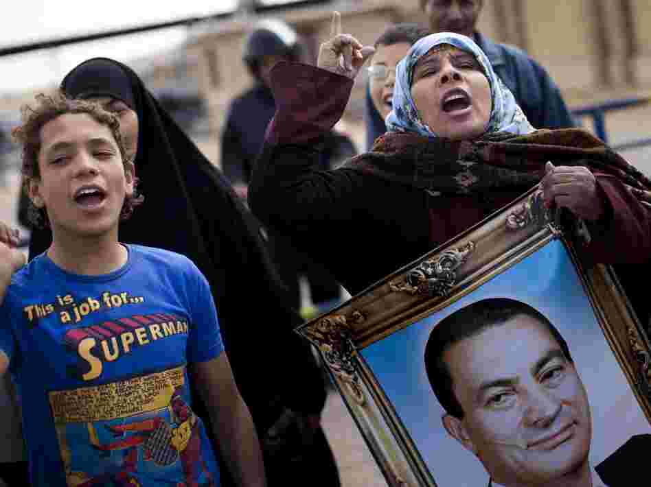Supporters of Mubarak in Cairo chant slogans and carry his portrait as they demonstrate in February during his trial, outside the police academy.