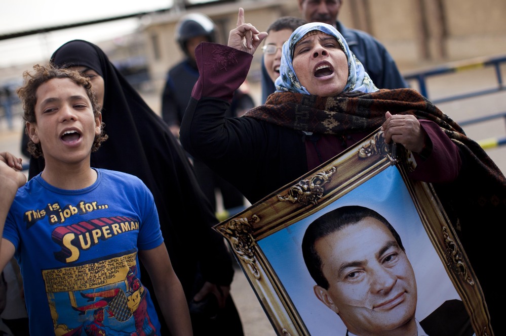 Supporters of Mubarak in Cairo chant slogans and carry his portrait as they demonstrate in February during his trial, outside the police academy.