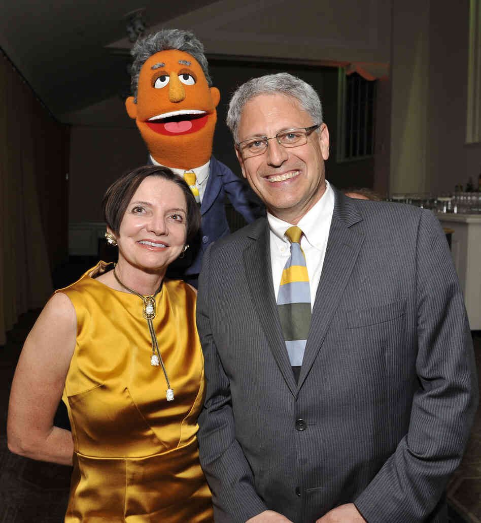 Jacki Lyden and Gary Knell pose with Gary Knell, the Muppet after the event. Jacki Lyden and Gary Knell pose with Gary Knell, the Muppet after the event.