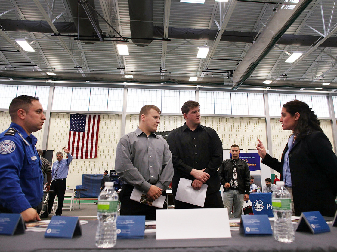 Military veterans Kris Hummel (l) and Shane Foley, speak with a TSA representative at a May 15, 2012 job fair in Utica, NY.