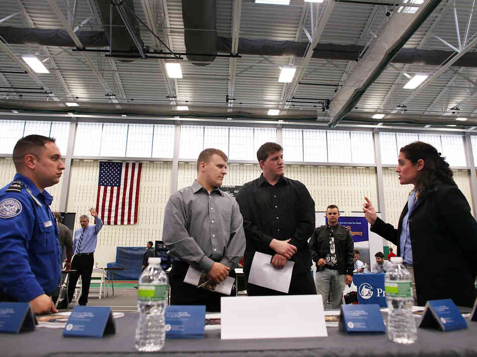 Military veterans Kris Hummel (l) and Shane Foley, speak with a TSA representative at a May 15, 2012 job fair in Utica, NY.