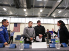 Military veterans Kris Hummel (l) and Shane Foley, speak with a TSA representative at a May 15, 2012 job fair in Utica, NY. Military veterans Kris Hummel (l) and Shane Foley, speak with a TSA representative at a May 15, 2012 job fair in Utica, NY.