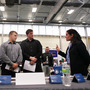 Military veterans Kris Hummel (l) and Shane Foley, speak with a TSA representative at a May 15, 2012 job fair in Utica, NY.