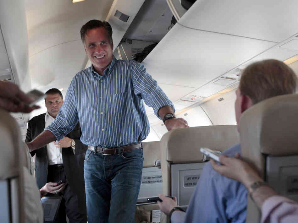 Republican presidential candidate Mitt Romney speaks to reporters on his campaign charter plane Monday in San Diego.