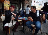 Since the revolution last year, Tunisians have had greater freedom to express their opinions on political and social issues. But the rise of Islamist groups has made religion a more sensitive topic. Here, two men chat at a cafe in the capital Tunis.