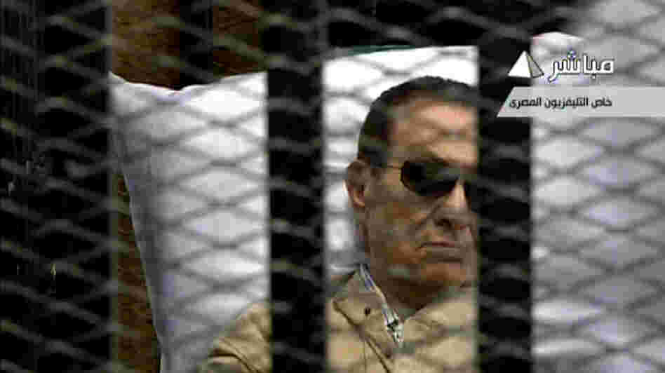An image grab taken from Egyptian state TV shows ousted Egyptian president Hosni Mubarak sitting inside a cage in a courtroom during his verdict hearing in Cairo Saturday.