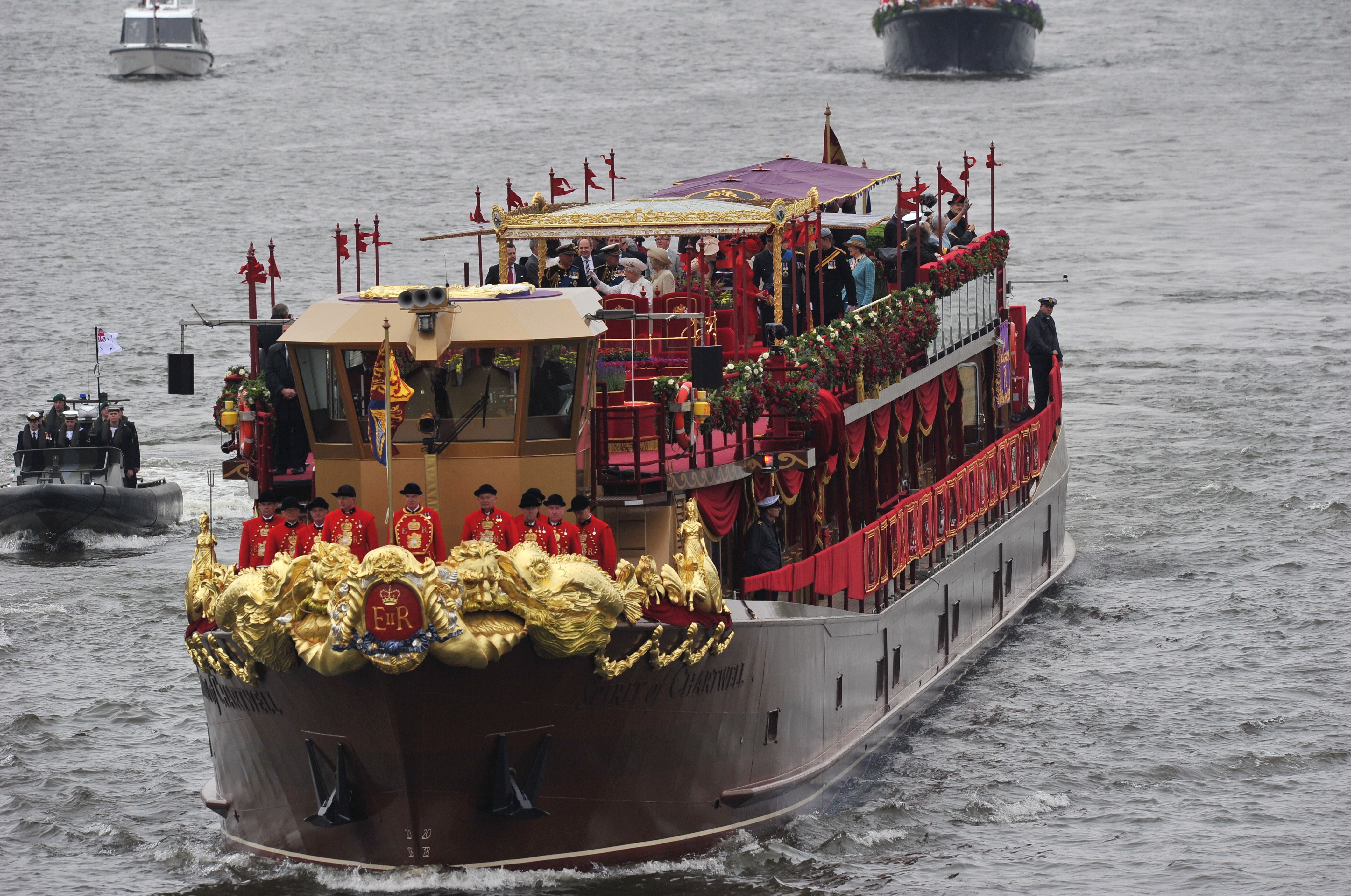 The queen traveled aboard the royal barge Spirit of Chartwell, decorated for the occasion in rich red, gold and purple velvet.