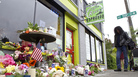 A memorial outside Seattle's Cafe Racer on Thursday, a day after a deadly shooting inside. Just a few days later, musicians gathered outside the coffeehouse for an improvised memorial jam session. A memorial outside Seattle's Cafe Racer on Thursday, a day after a deadly shooting inside. Just a few days later, musicians gathered outside the coffeehouse for an improvised memorial jam session.