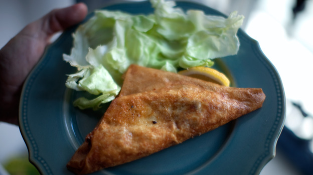 Steve Inskeep displays his "bric," a fried pastry containing runny egg and canned tuna.