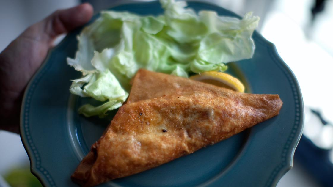 Steve Inskeep displays his "bric," a fried pastry containing runny egg and canned tuna.