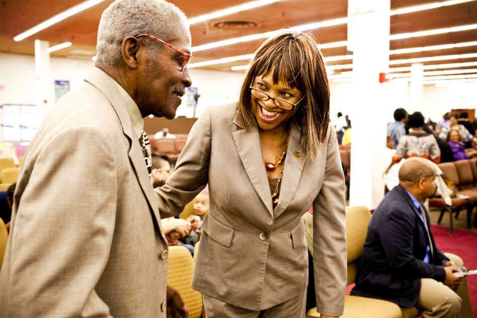 Natasha Shamone-Gilmore smiles at her father, Franklin Brunson, 81, during a Sunday church service in Capitol Heights, Md. She has taken on the daily challenge of caring for her father, who is suffering from mild dementia.