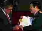 Vietnamese Minister of Defense Phuong Quang Thanh (right) presents the personal letters of U.S. Army Sgt. Steve Flaherty to Defense Secretary Leon Panetta.