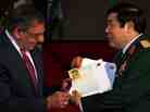 Vietnamese Minister of Defense Phuong Quang Thanh (right) presents the personal letters of U.S. Army Sgt. Steve Flaherty to Defense Secretary Leon Panetta.
