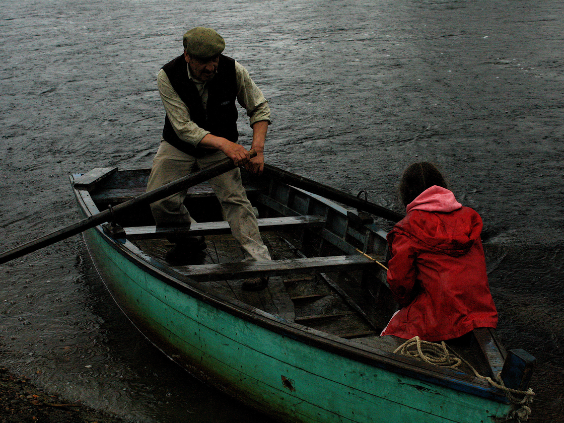 Lalo Sandoval and his granddaughter Sara row the Baker River in Chile. Many of the residents of the Patagonia river valleys still travel via ox cart and small boat.