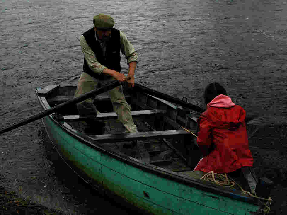 Lalo Sandoval and his granddaughter Sara row the Baker River in Chile. Many of the residents of the Patagonia river valleys still travel via ox cart and small boat.