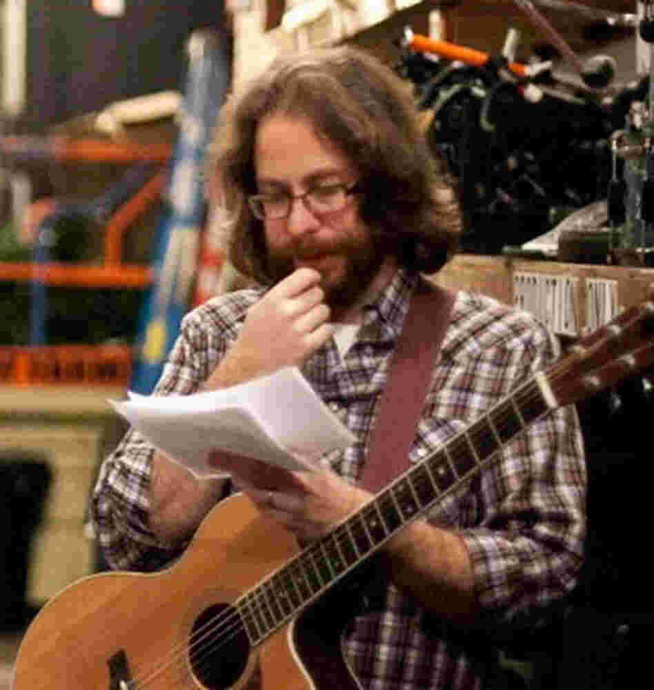 Ask Me Another house musician, Jonathan Coulton, puzzles over papers before a show taping.