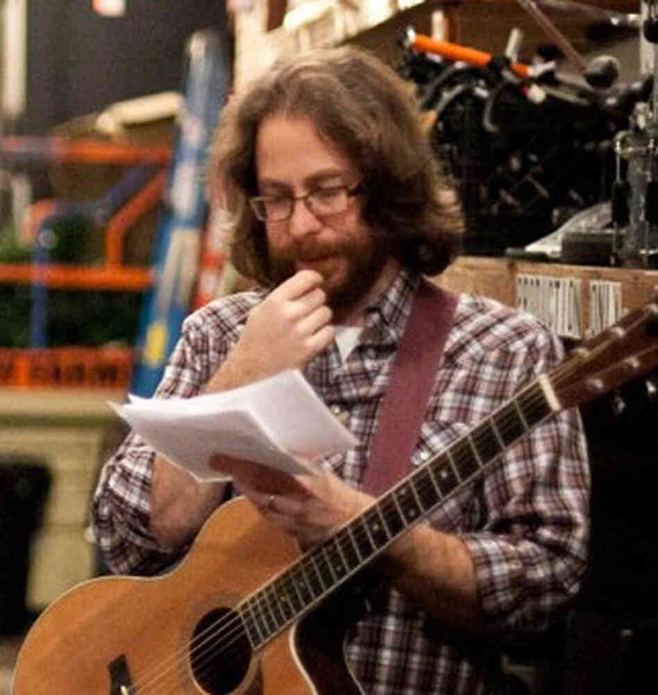 Ask Me Another house musician, Jonathan Coulton, puzzles over papers before a show taping.