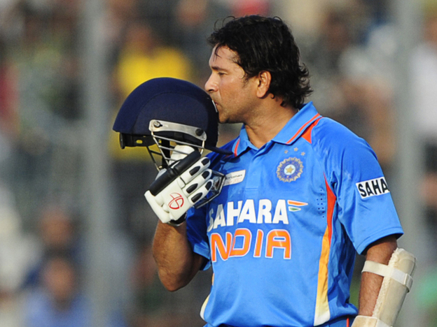 Sachin Tendulkar kisses his helmet after scoring his 100th century (100 runs) in a March match against Bangladesh.