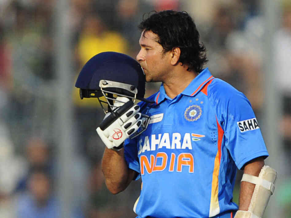 Sachin Tendulkar kisses his helmet after scoring his 100th century (100 runs) in a March match against Bangladesh.