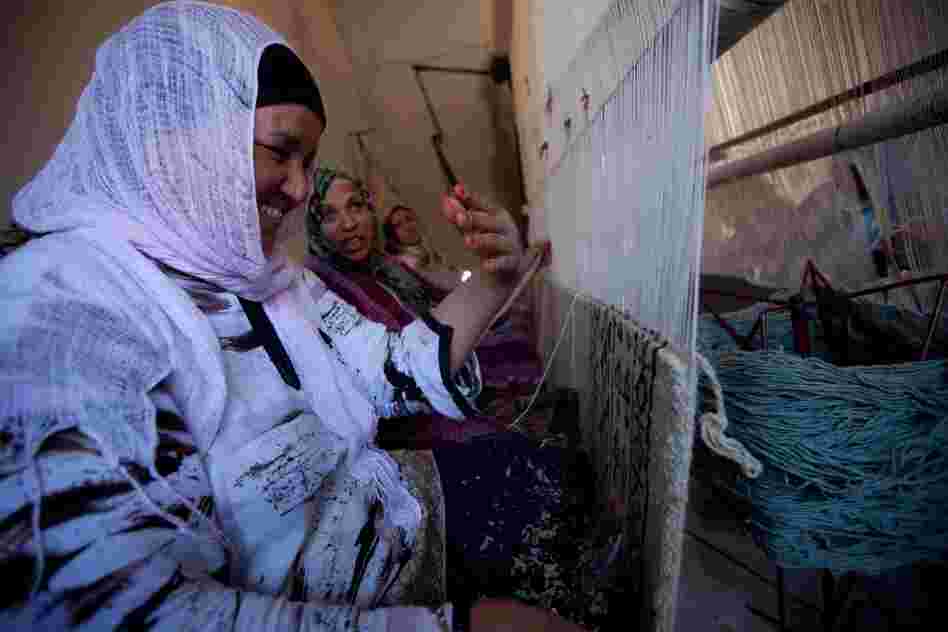 Workers at a carpet-making business in the town of Kairouan are paid about $2.50 a day. Many carpet buyers are tourists, but the number of foreign visitors has dropped since the revolution.