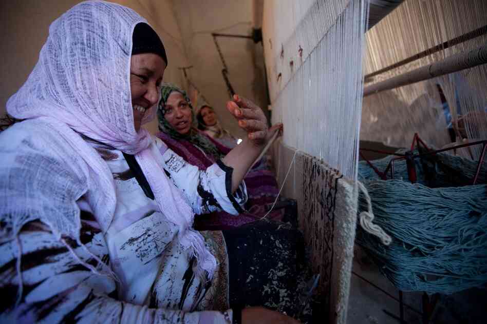 Workers at a carpet-making business in the town of Kairouan are paid about $2.50 a day. Many carpet buyers are tourists, but the number of foreign visitors has dropped since the revolution.