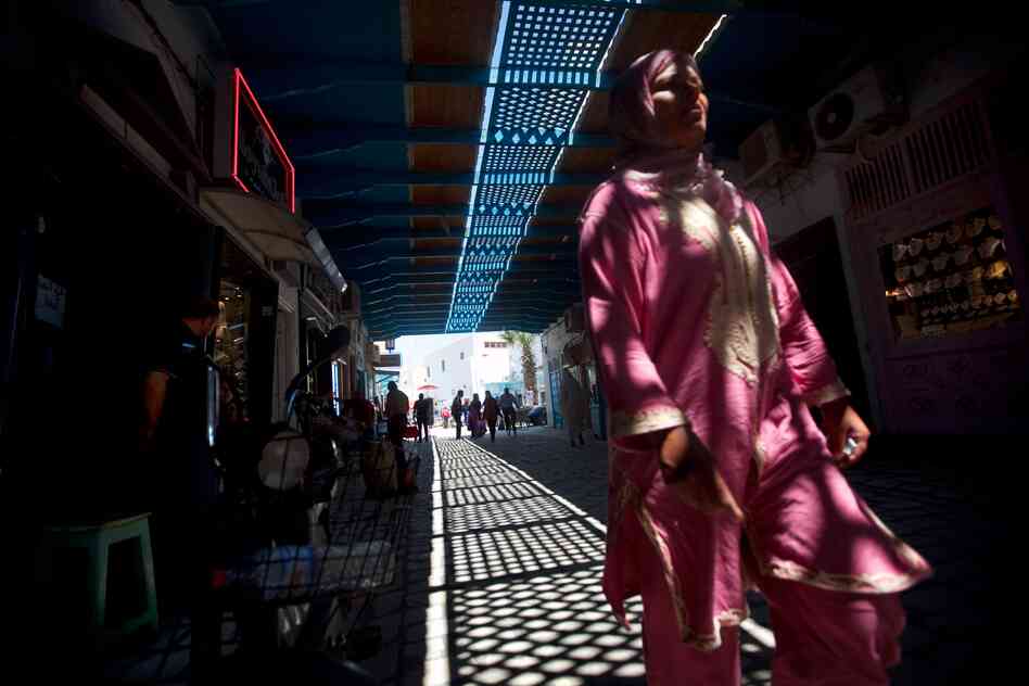 A woman walks through the marketplace in Kairouan, where some street scenes from Raiders of the Lost Ark were filmed.