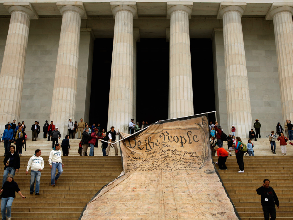Volunteers unfurl a banner  with the Preamble to the Constitution during a demonstration against the Supreme Court's Citizens United ruling on campaign finance rules at the Lincoln Memorial in Washington, D.C., Oct. 20, 2010.