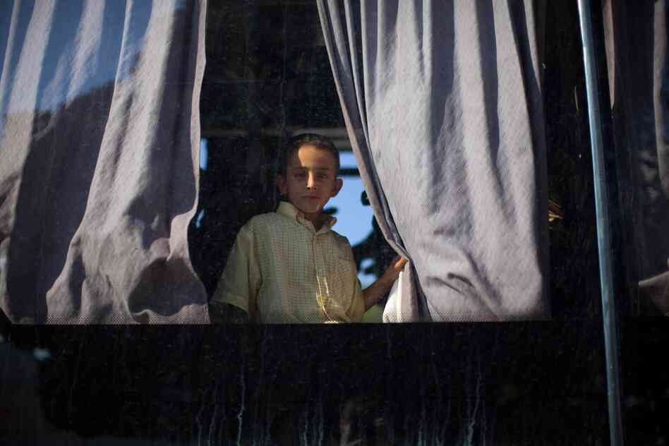 A boy peers out a bus window in the Tunis suburb of Sidi Bou Said.