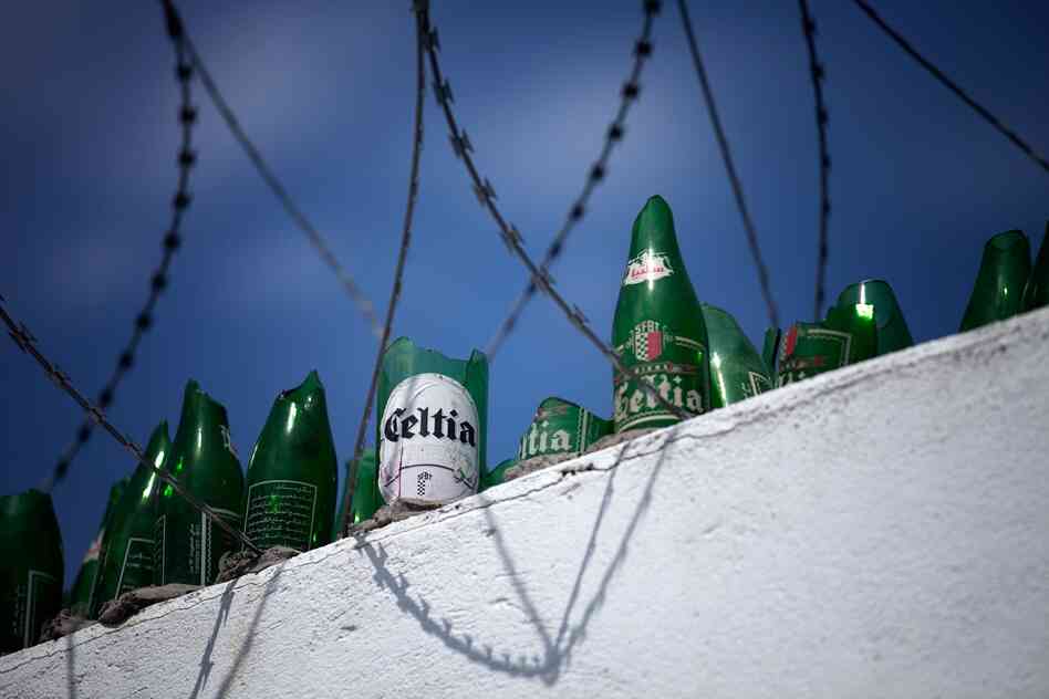 The wall surrounding the Celtia brewery is about 12-feet high and topped with razor wire and broken beer bottles. The brewery is owned by the state, and the government is currently controlled by the Islamist party Ennahda.