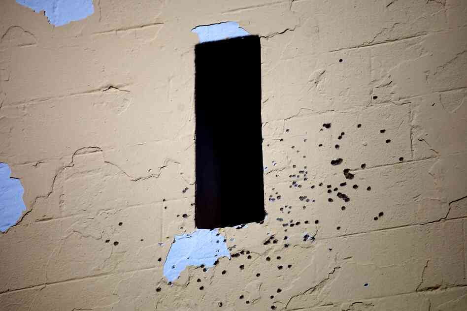 Buckshot pockmarks the outside of a mosque in Sidi Bouzid, where there  have been confrontations over the presence of liquor stores.
