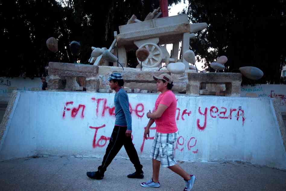 A monument to Mohammed Bouazizi, a fruit seller who touched off the Arab Spring by setting himself on fire in the central Tunisian town of Sidi Bouzid. The graffiti reads, "For Those Who Yearn To Be free."