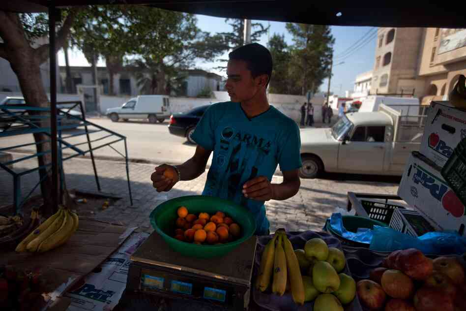 A vendor sells fruit in the same market area where  Bouazizi worked.