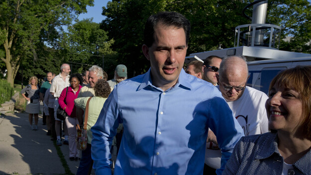 Wisconsin Gov. Scott Walker waits in line to vote Tuesday in Wauwatosa, Wis.