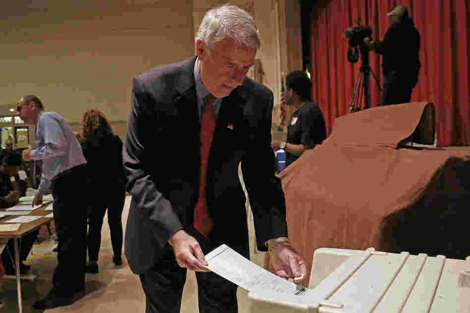 Barrett puts his ballot into a machine after voting in Milwaukee.