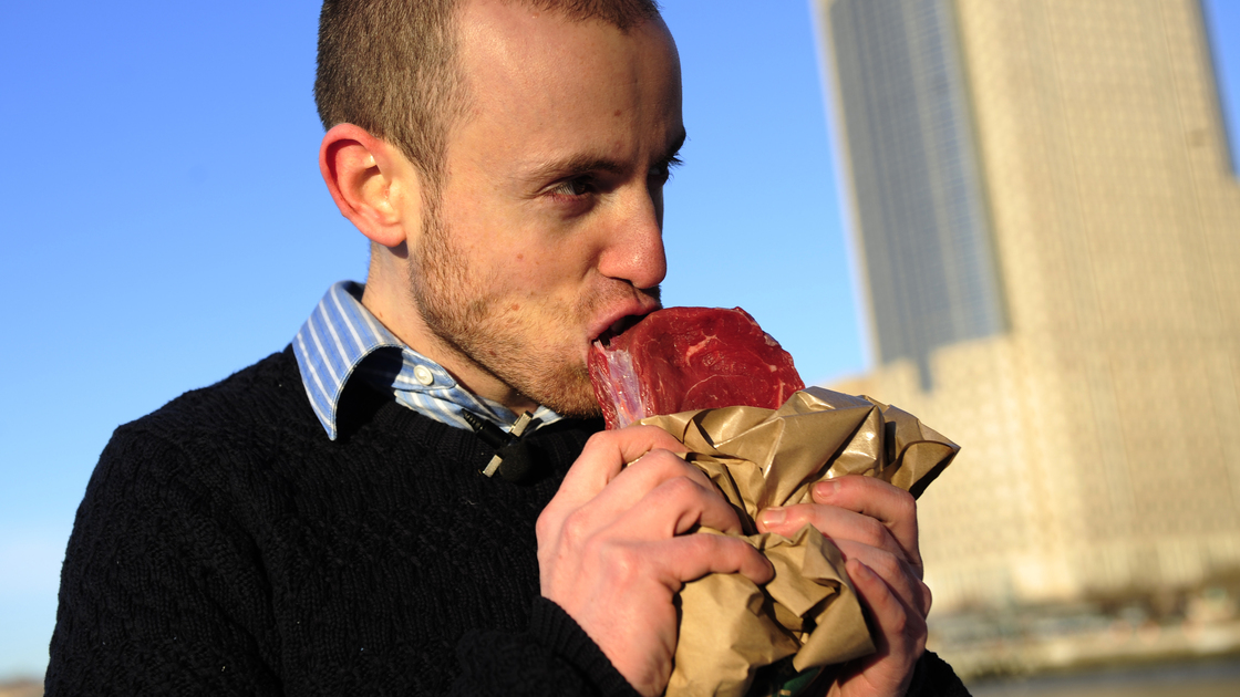 Vlad Averbukh, 29, a follower of the paleo diet, eats raw meat along the Hudson River in New York in 2010. (Averbukh did not weigh in on our blog post on the paleo diet.)