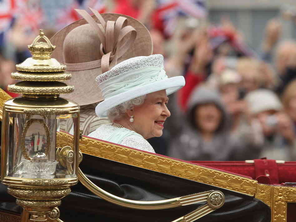 Queen Elizabeth II, as she rode toward Buckingham Palace earlier today. The Duchess of Cornwall (Camilla) rode beside her. Also in the carriage: the Prince of Wales (Charles).