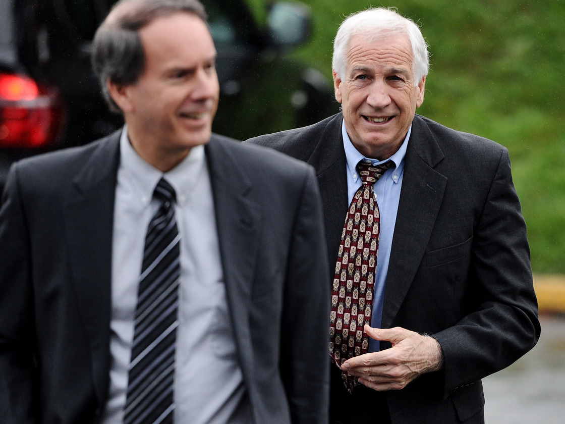Former Penn State football assistant coach Jerry Sandusky (right) walks to the county courthouse on June 5, the first day of his trial on child sex abuse charges.