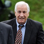 Former Penn State football assistant coach Jerry Sandusky (right) walks to the county courthouse on June 5, the first day of his trial on child sex abuse charges.